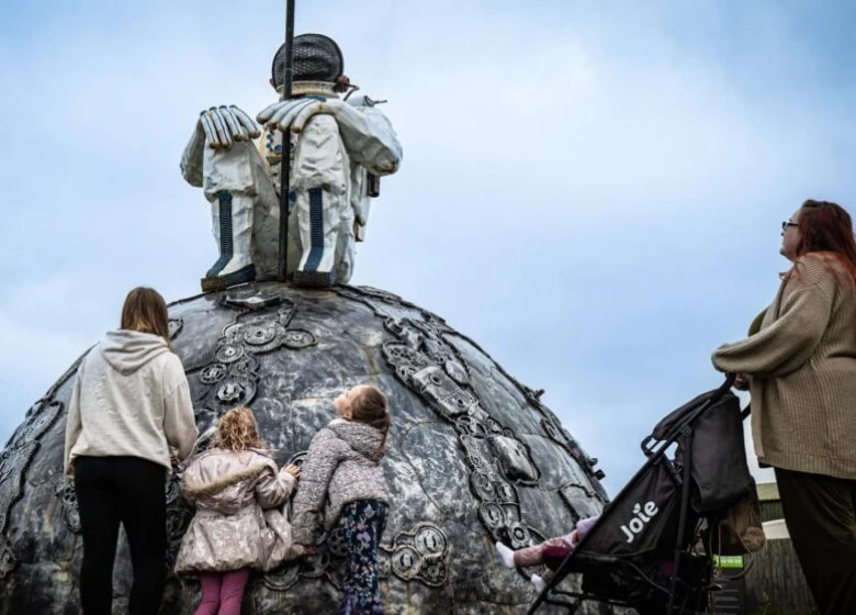 A family looking at a monument