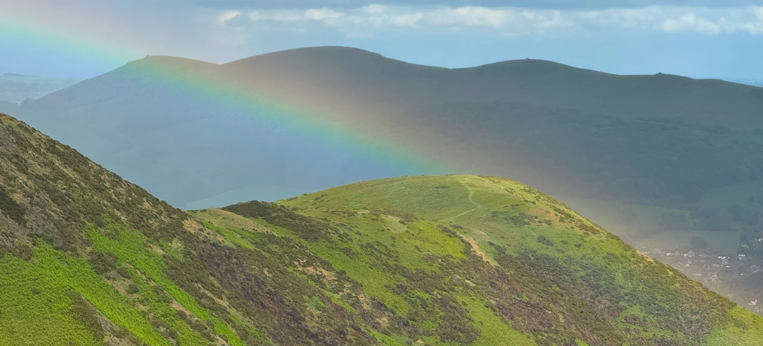Spring at the Shropshire Hills - mountain edges with a rainbow over