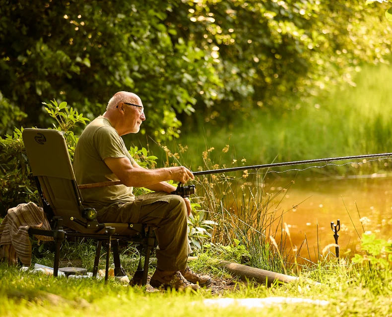 Man fishing on Long Mynd, Betchcott Fishing Lake