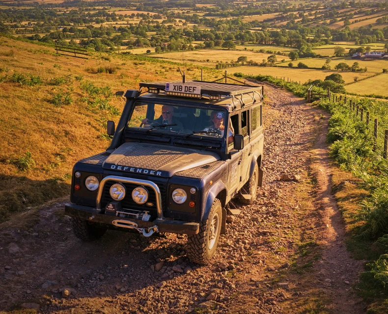 The Defender driving through the Hills